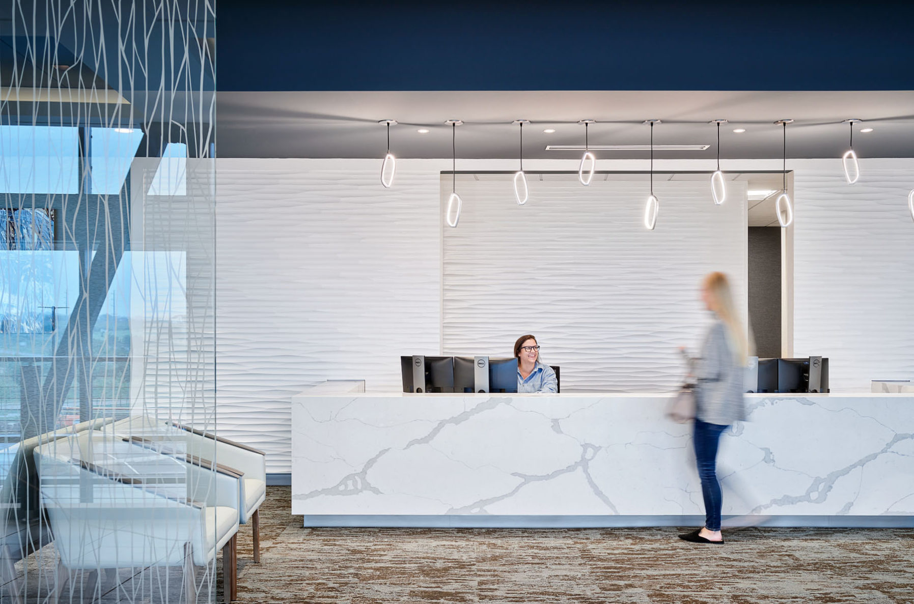 An employee and patient at the front desk of the new LMH West in Lawrence, KS