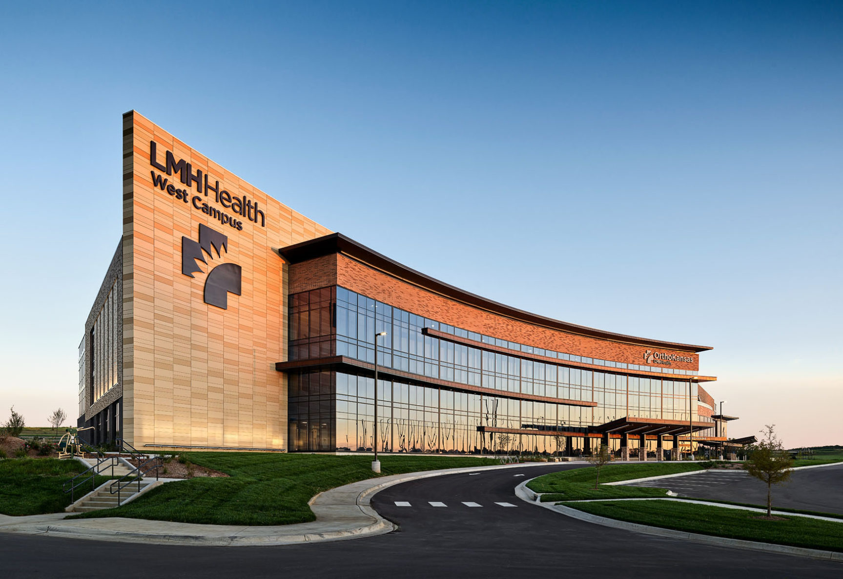 LMH Health West during sunset. The sunset is reflecting off of the many windows