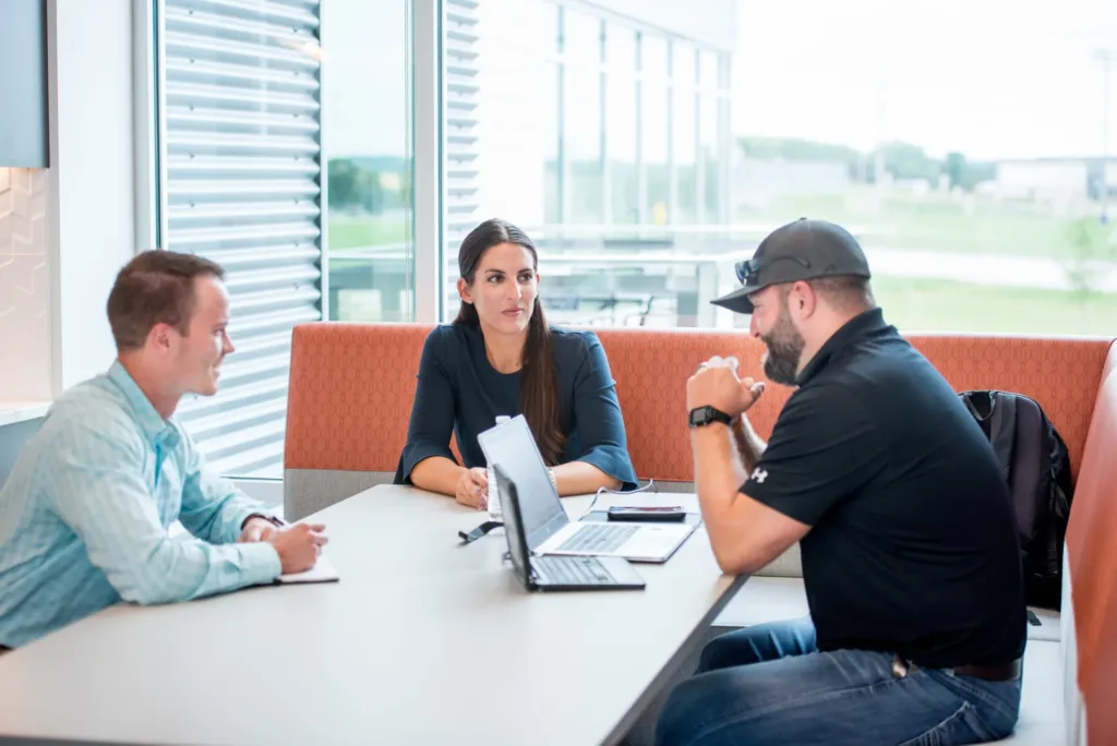 people at a table discussing the project approach for construction