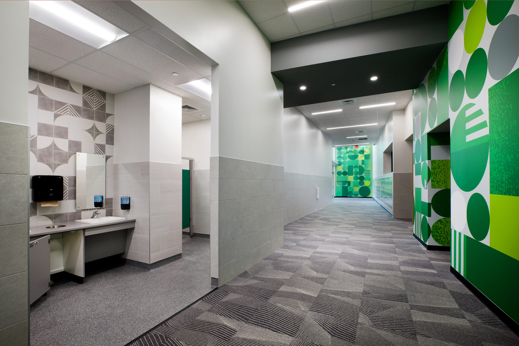 stone creek bathroom hallway that features bright green wall designs