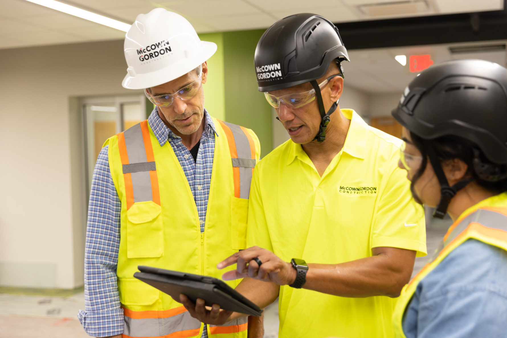 McCownGordon employees looking at an ipad on a construction site