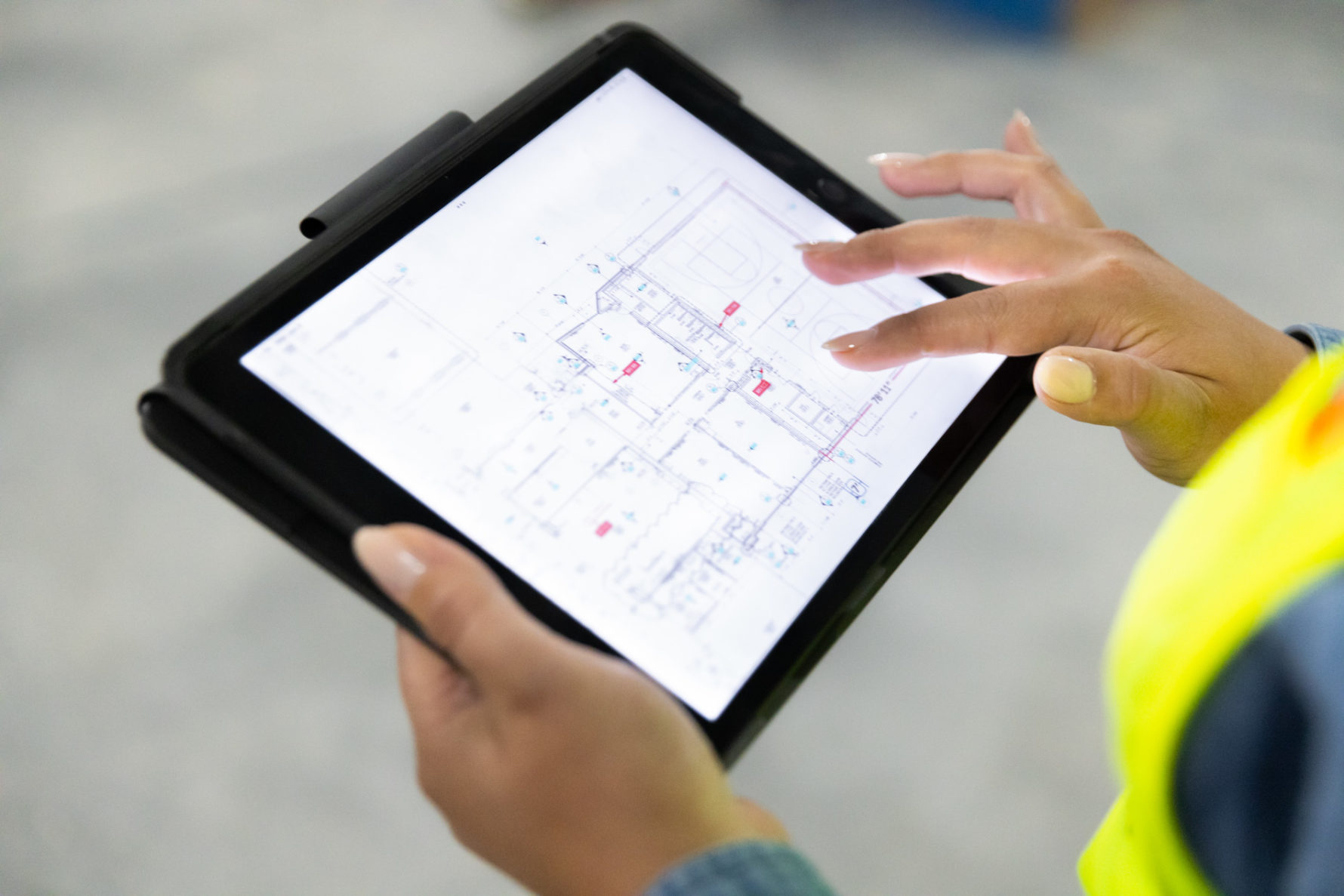 An ipad with construction drawings being used by a McCownGordon Construction associate