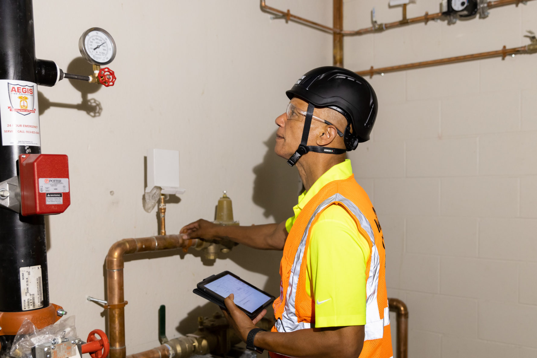 A McCownGordon Construction associate from the commissioning team examining systems on a job site