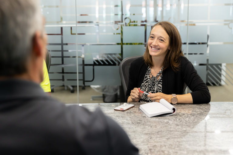 A McCownGordon Construction laughing while in a meeting in the office