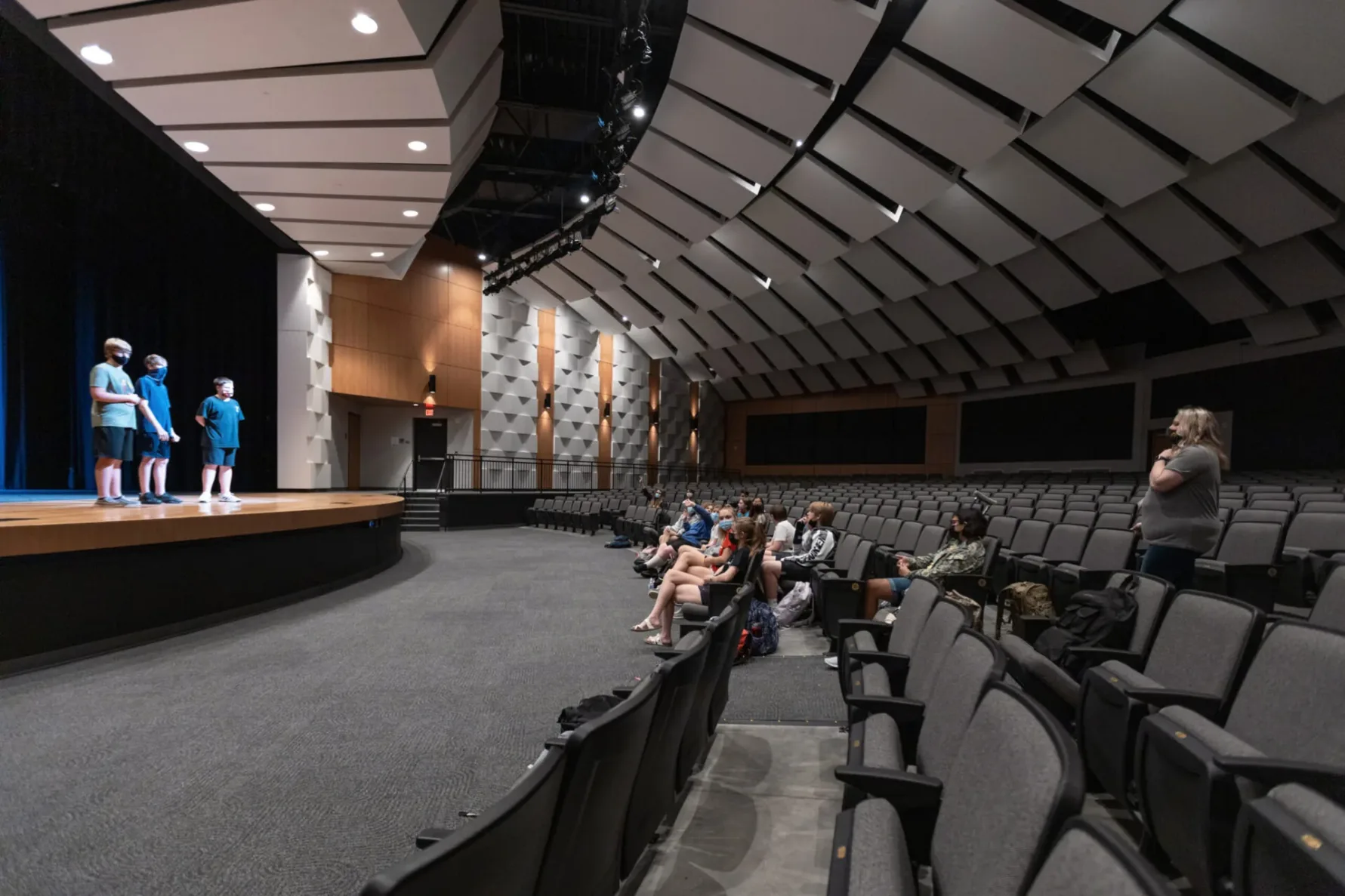 Students on stage at the Performing Arts Center at Basehor Linwood Middle School, built by McCownGordon.
