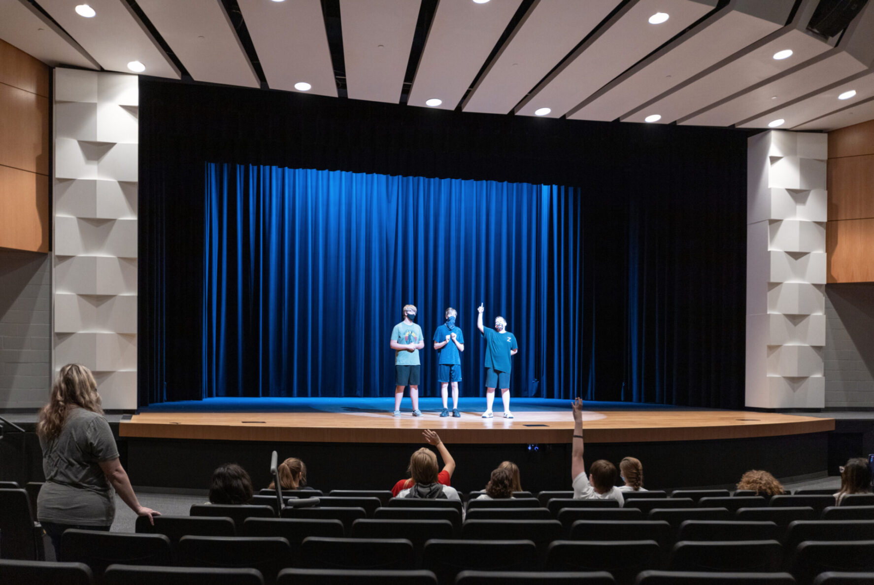 Students on stage at the Performing Arts Center at Basehor Linwood Middle School, built by McCownGordon.