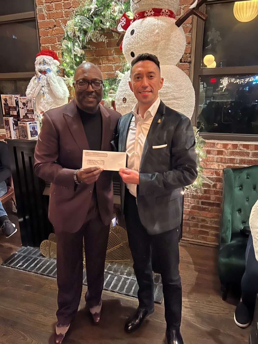 Pat Contreras presenting a holiday donation to the Negro Leagues Baseball Museum in Kansas City to support them.