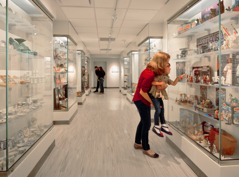 people looking at the miniature toys