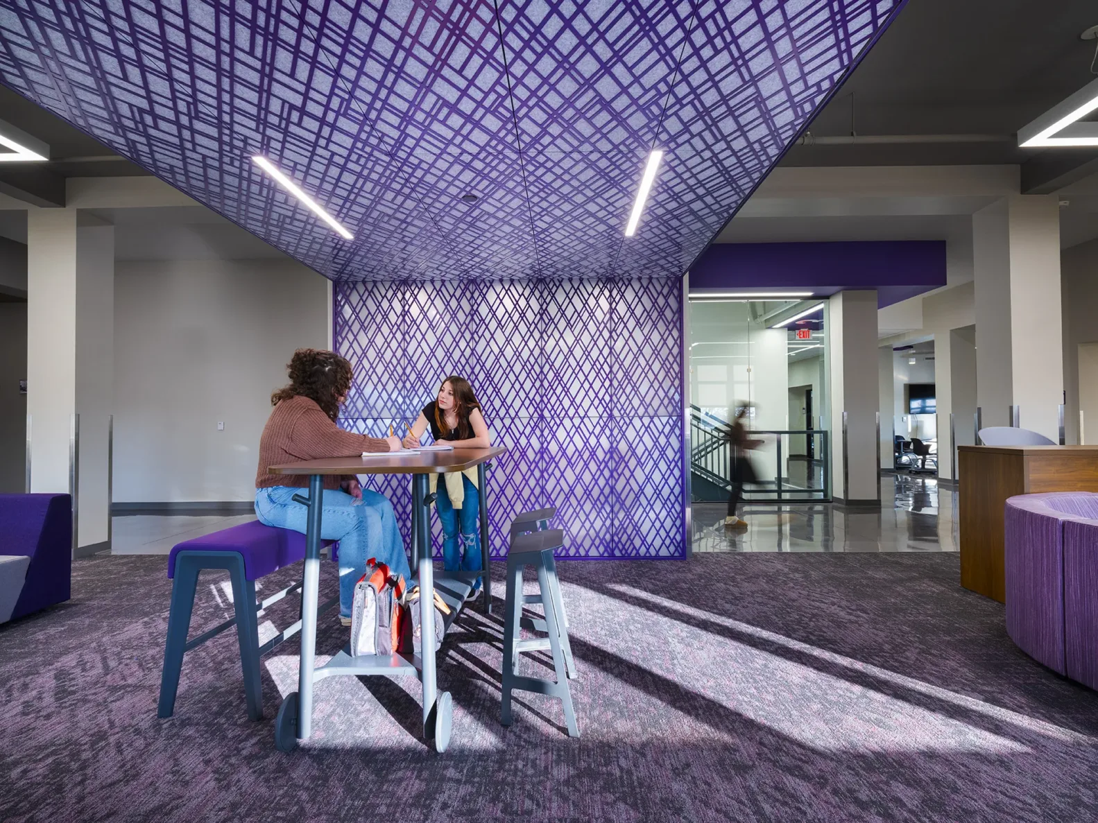 Students collaborating in a purple hallway at Pittsburg Community Middle School