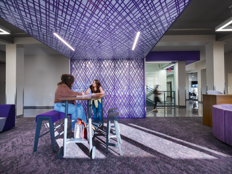 Students collaborating in a purple hallway at Pittsburg Community Middle School