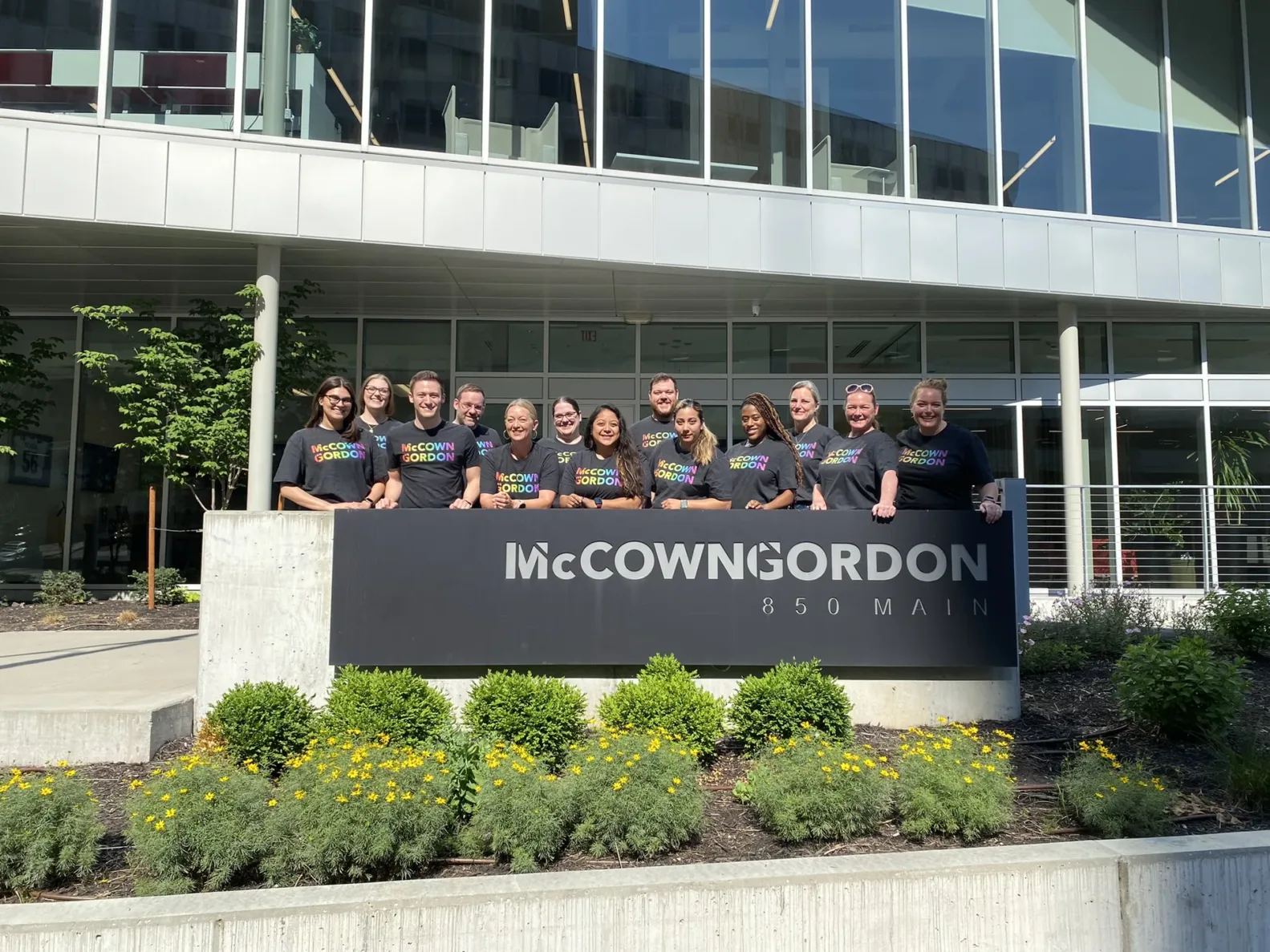 McCownGordon's Pride Business Resource Group standing outside the front of the building for a photo