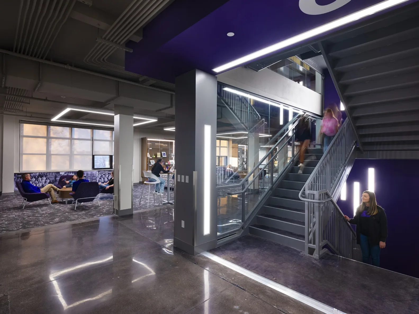 Students walking down the stairs into a commons are at Pittsburg Community Middle School