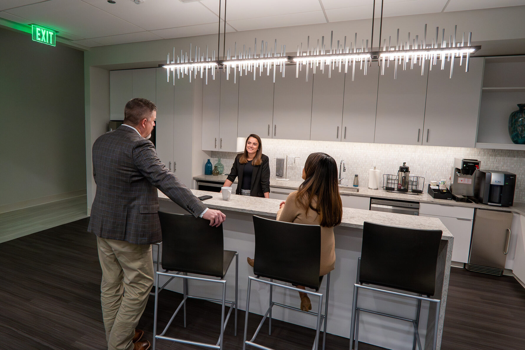 Associates speaking in the kitchen at CrossFirst Bank's Fort Worth, Texas location