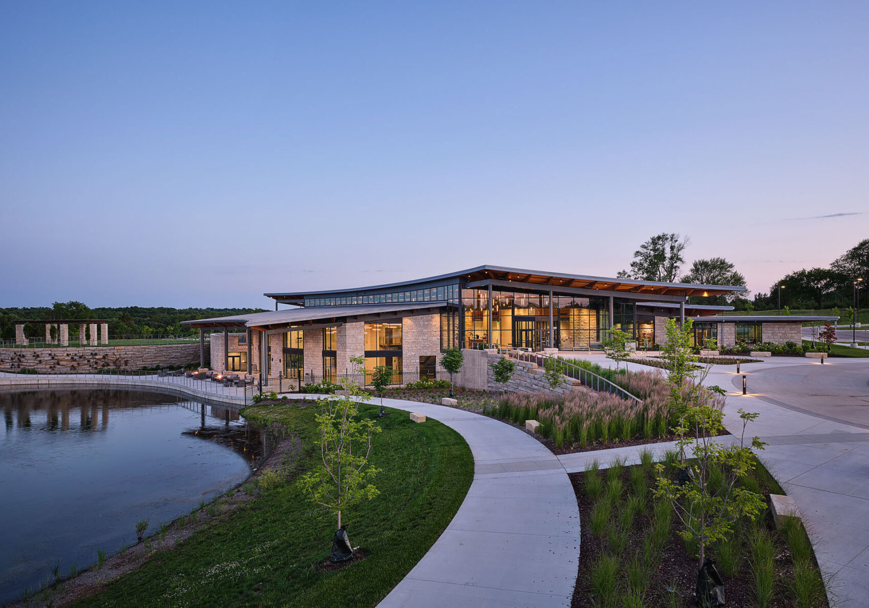 City of Overland Park Arboretum at night with lights on and overlooking the pond