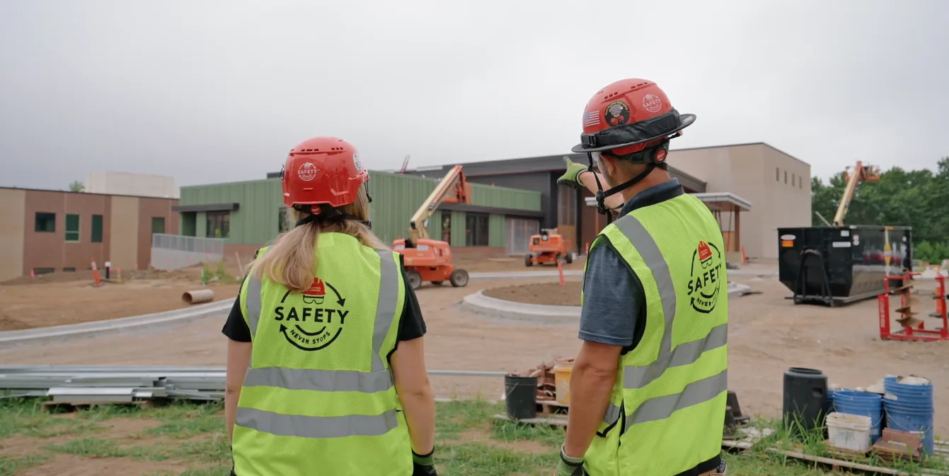 Two McCownGordon Construction associates talking on the job site of a school being built