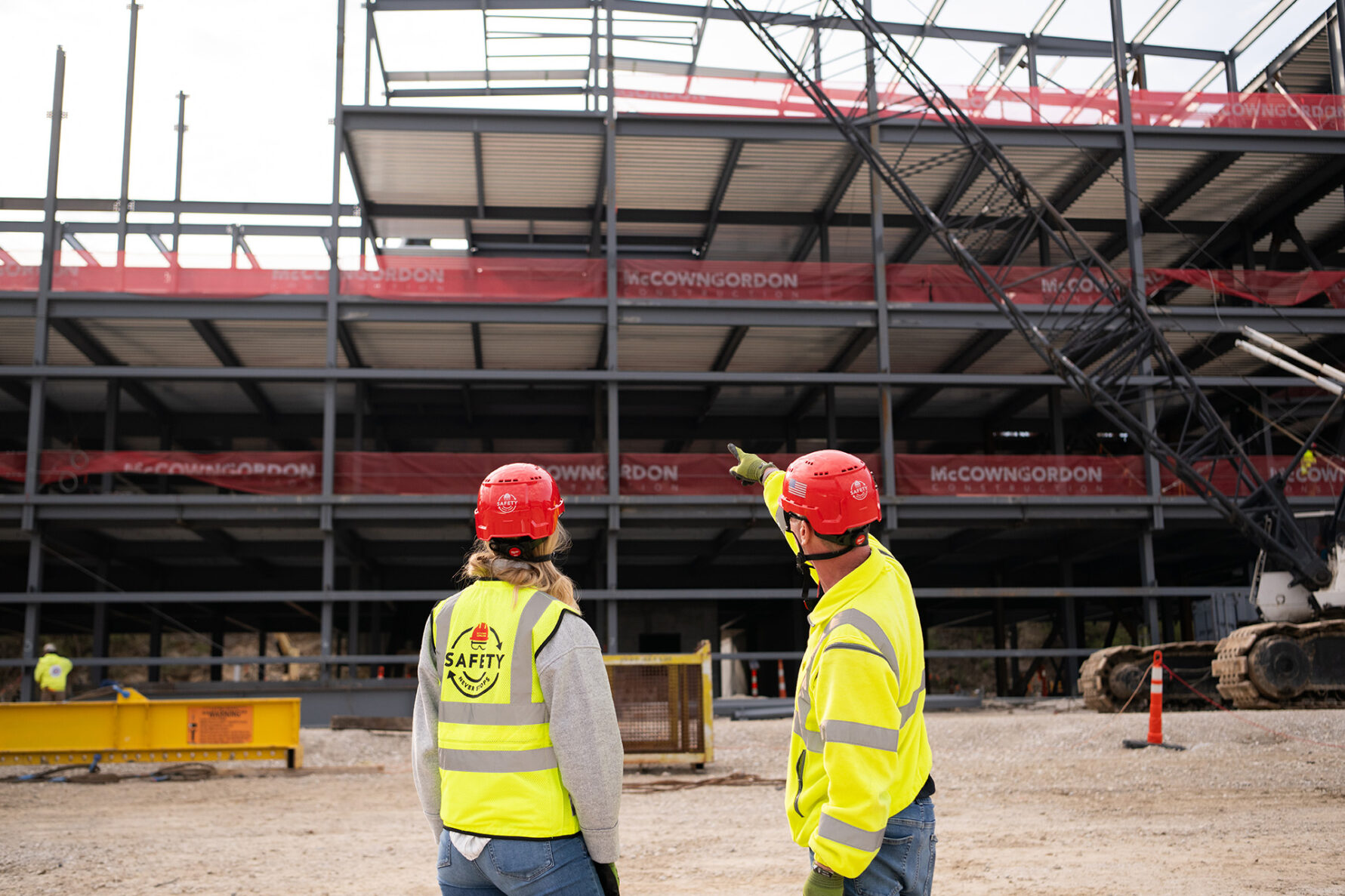 Two McCownGordon associates on a jobsite pointing at the progress
