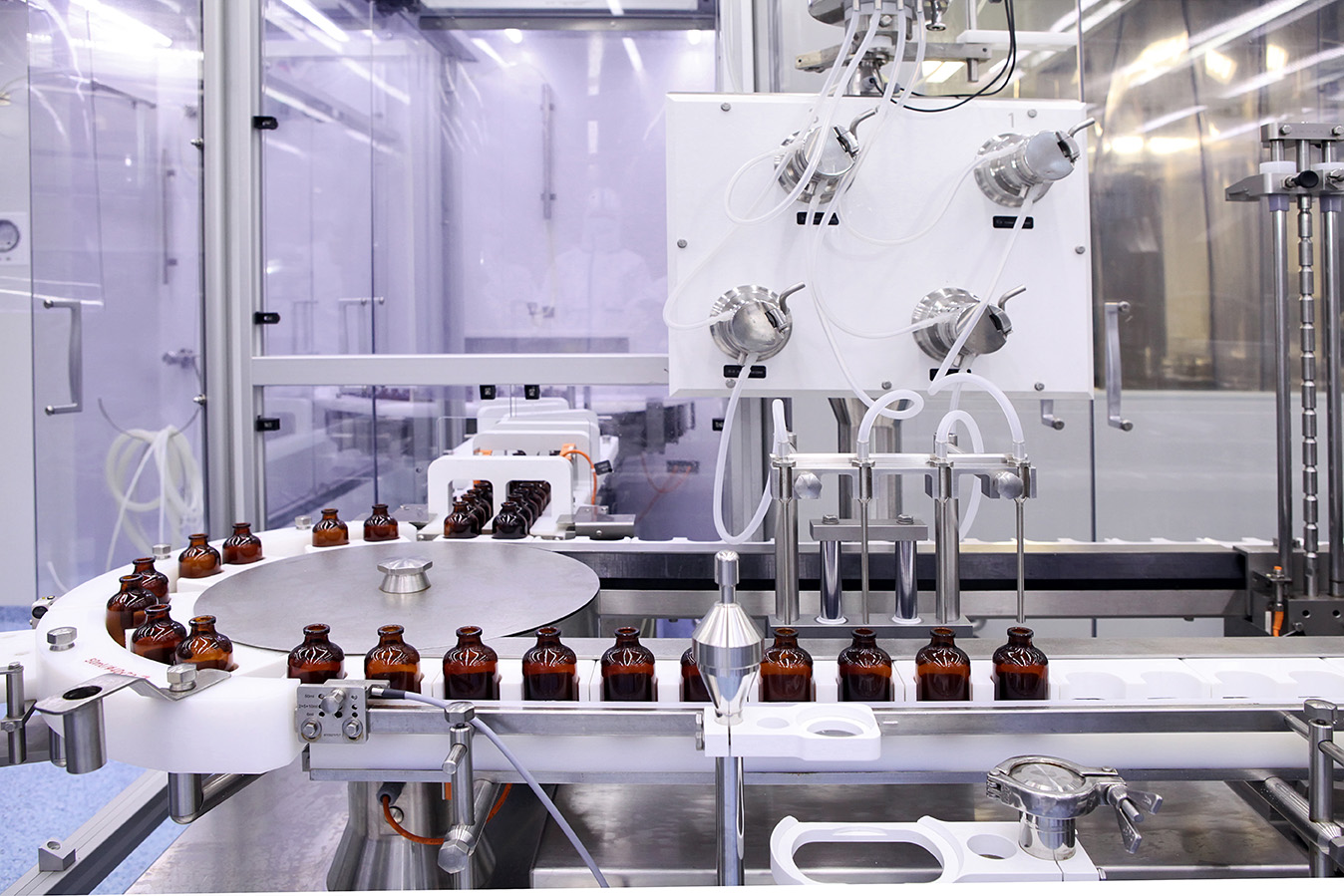Sterile bottles and ampoules on the dispensing line at a pharmaceutical manufacturing facility