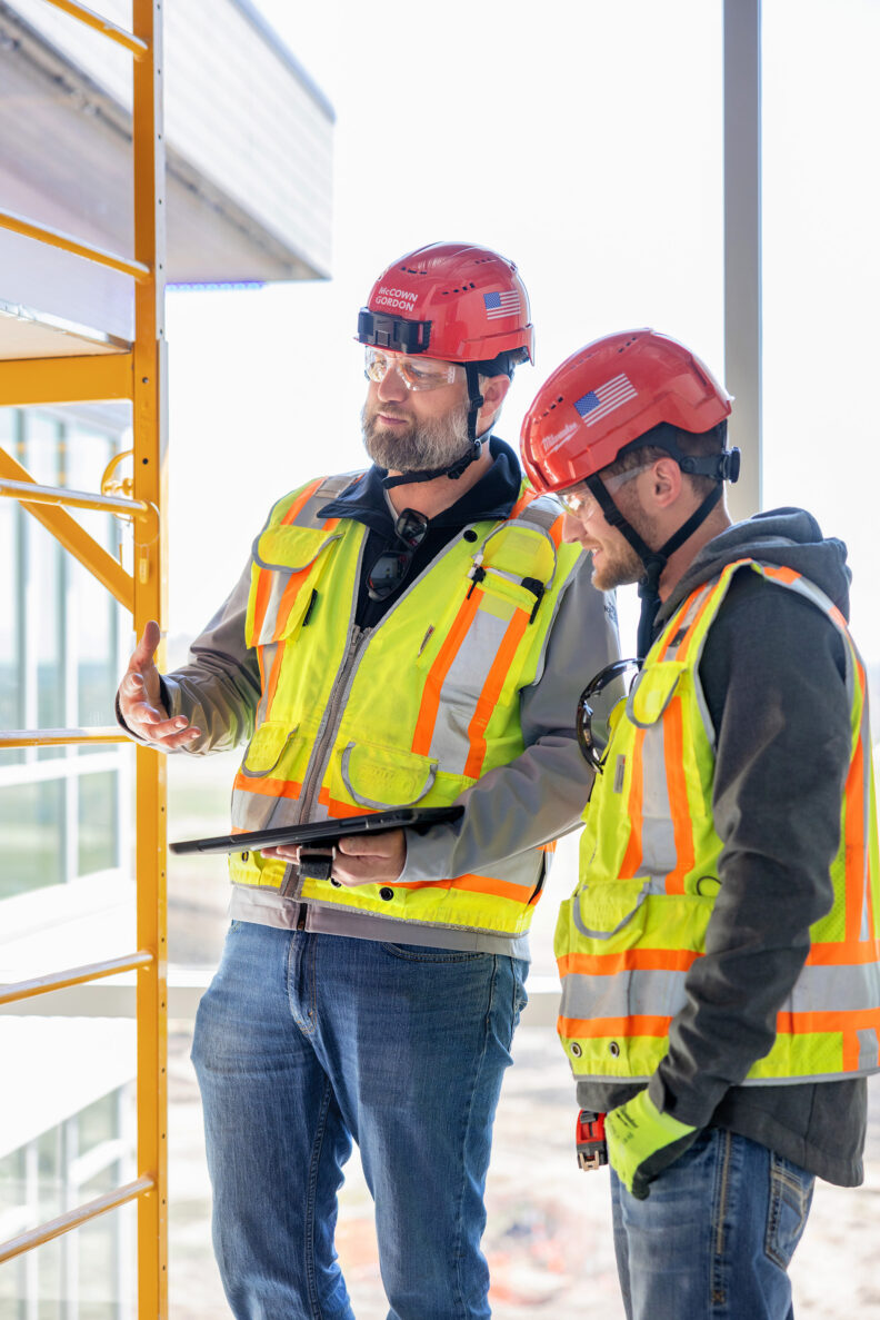 McCownGordon associates talking on jobsite.