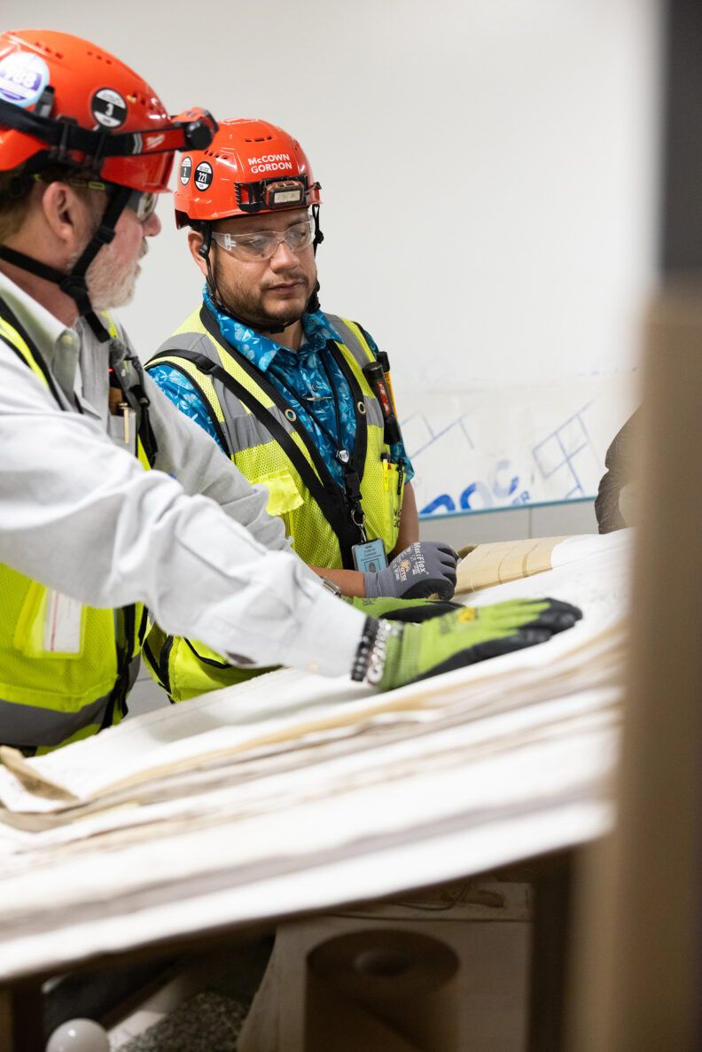 McCownGordon associates talking about plans on jobsite.